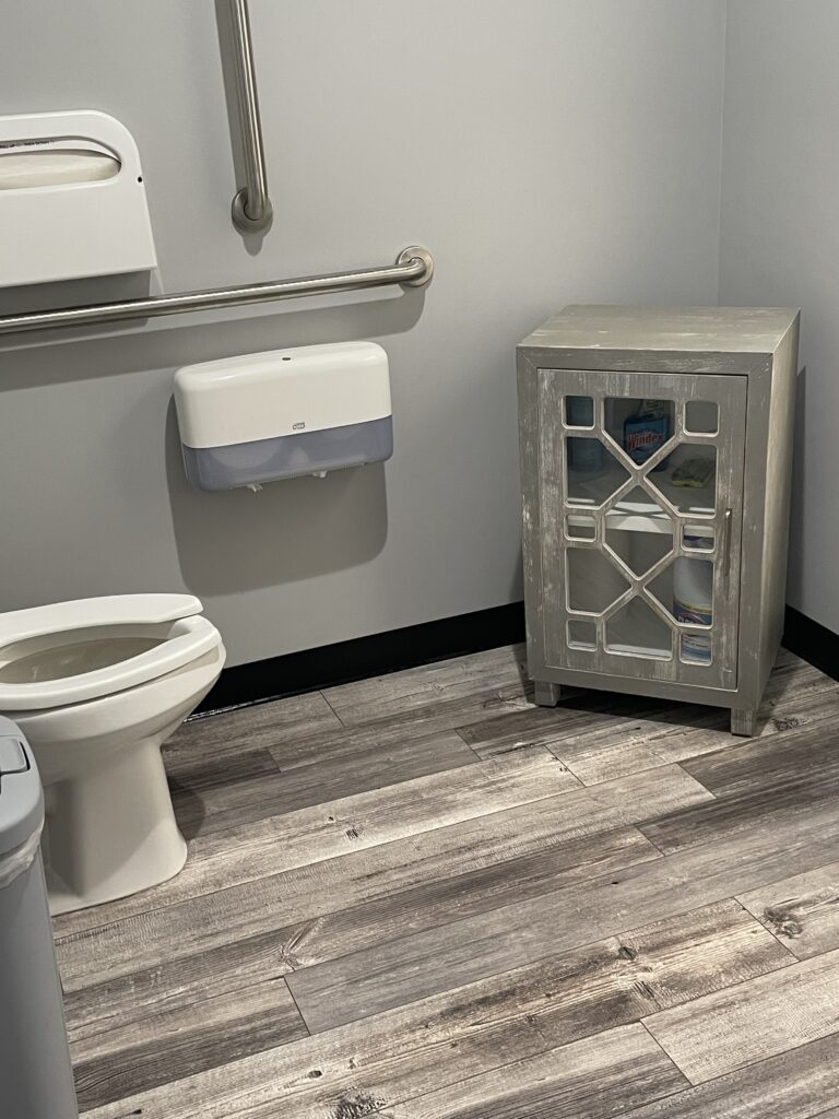 A bathroom with wooden style floor